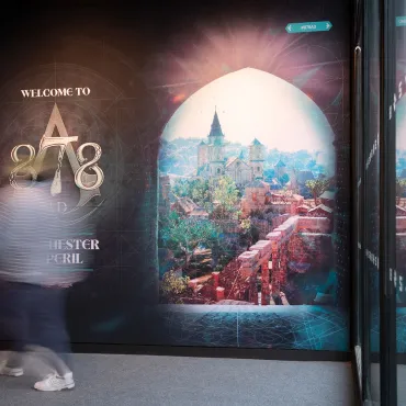 A large graphic of an anglo-saxon town on a wall next to a logo for 878 AD