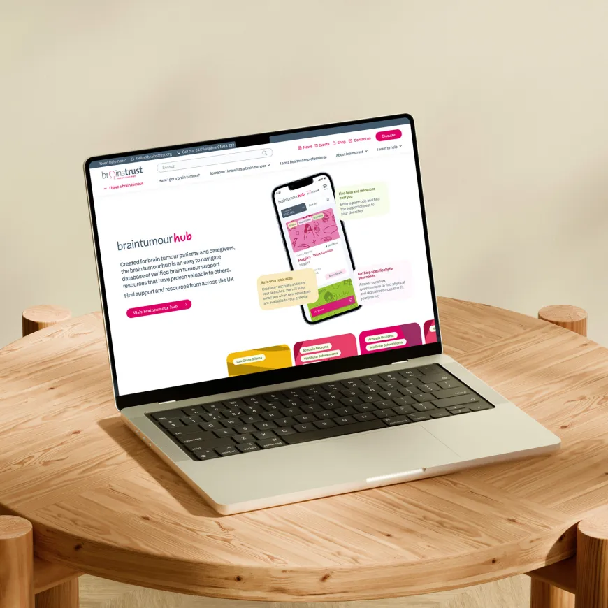 Laptop displaying the brain tumour hub advertisement on brainstrust website.
