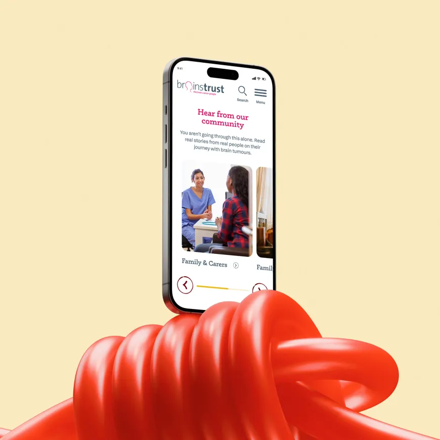 Mobile phone mockup up balancing on a red elastic knotted string.