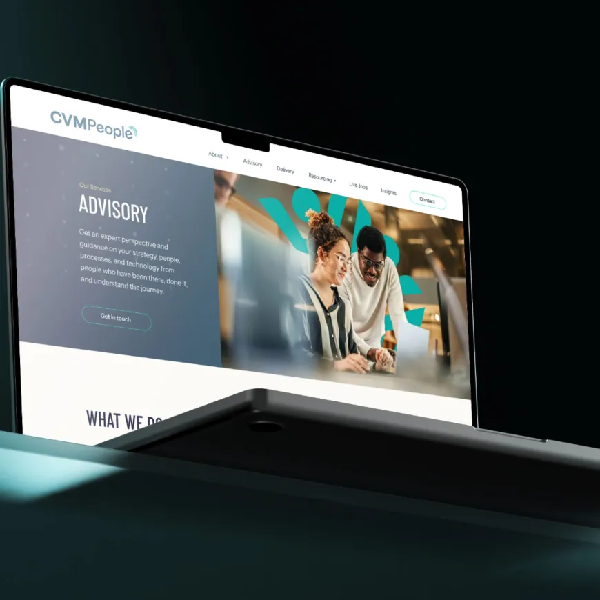 a laptop on a green table with the CVM people website on display