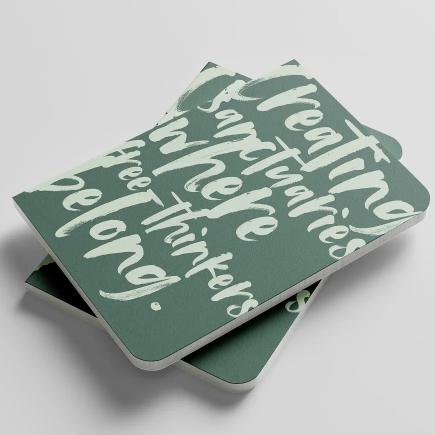 Green notepad with sage green writing on the cover.