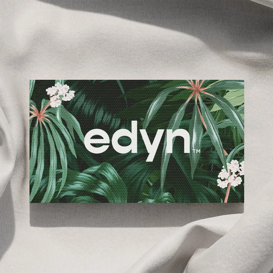 Tropical Edyn business card on a linen fabric background.