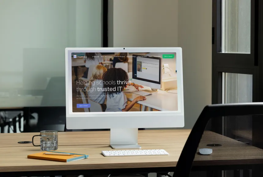Desktop on a desk with Harrap website on display