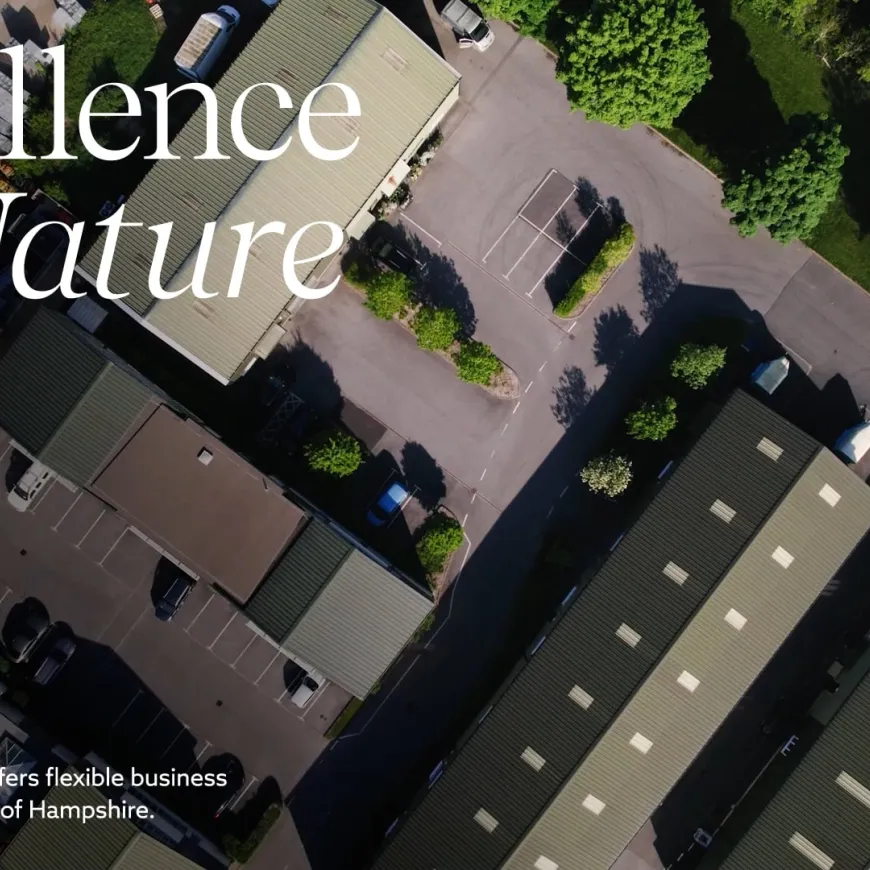 Aerial view of Hazely Enterprise Park with the headline “Excellence by Nature” over modern business units surrounded by trees
