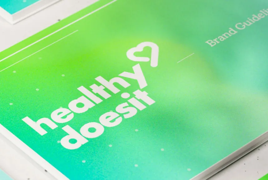 Lime green gradient covered brand guidelines books laid flat.