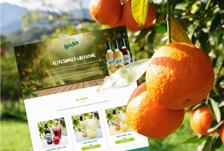 an orange tree with vibrant orange fruits, next to a digital render of the rocks drinks homepage