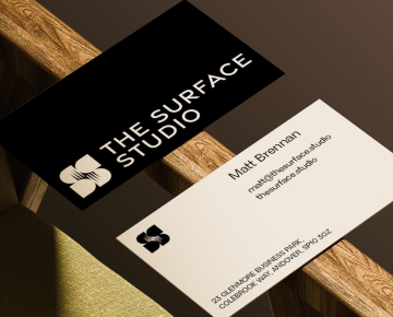 Branded business cards displayed on a wooden chair