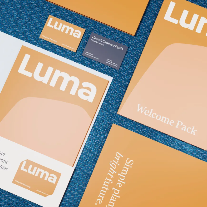 orange brochure graphic flatlayed on a blue background